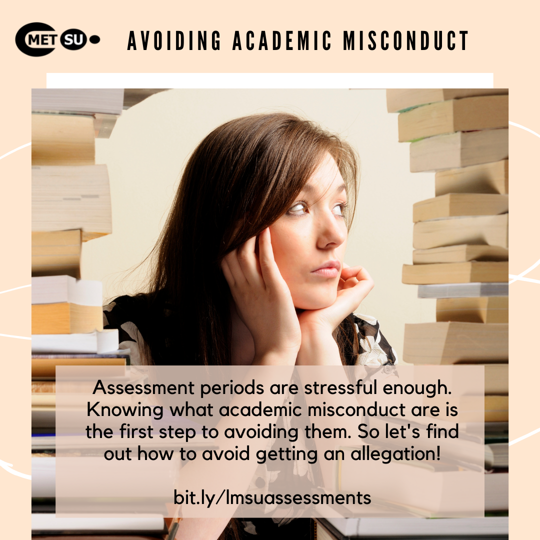 Female student looking in the distance, sitting next to stacks of books.